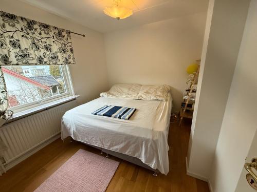 a small bedroom with a bed and a window at Villa Bliss in Surte