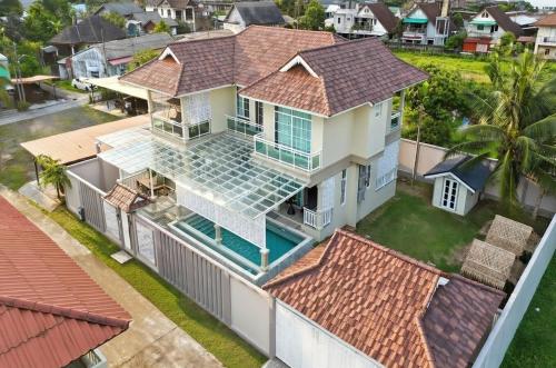 an aerial view of a house with a swimming pool at Kamala Beach Phuket - 4BR Private Luxury Pool Villa with Maid in Kamala Beach