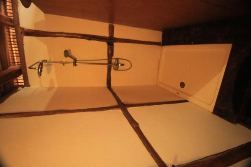 a bathroom with a shower in the corner of a room at Cottage sur la mer in Vilanculos