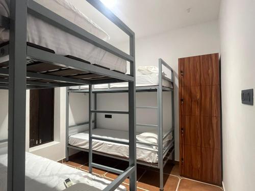 a bedroom with two bunk beds and a closet at Hostel Akeeka in Alleppey