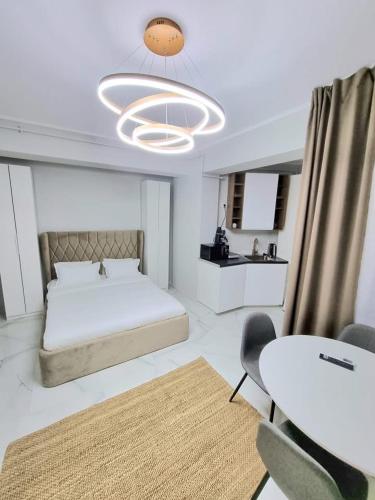 a bedroom with a bed and a table and chairs at VCV Apartments in Mamaia Sat/Năvodari