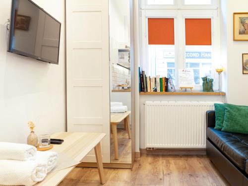 a living room with a couch and a table at Apartamenty Bydgostia Dworzec in Bydgoszcz