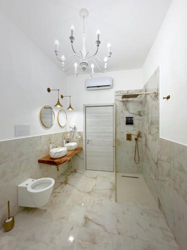 a bathroom with a toilet and a chandelier at B&B da Matteo in Telese