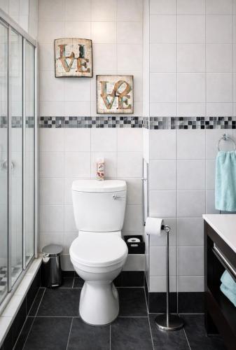 a bathroom with a toilet and a glass shower at Deja View in Knysna