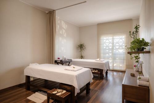 a room with two beds and a window at MGM Wellness Clinic in Aswan