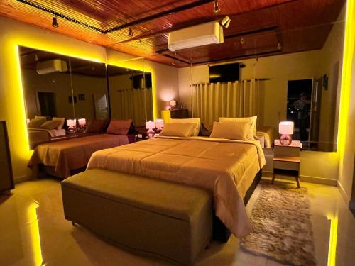 a large bedroom with two beds and a couch at Hotel KK 1021 in Coxim