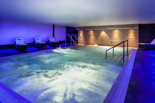 a large pool of water with chairs in it at The Daffodil Hotel & Spa in Grasmere
