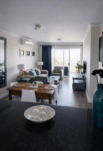 a living room with a couch and a table at Deja View in Knysna