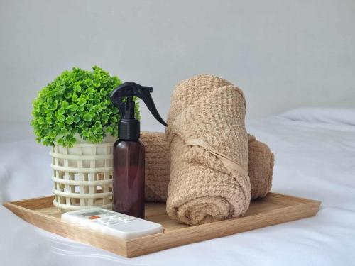 a wooden tray with a towel and a bottle of soap at 953 D shore 1 in Manila