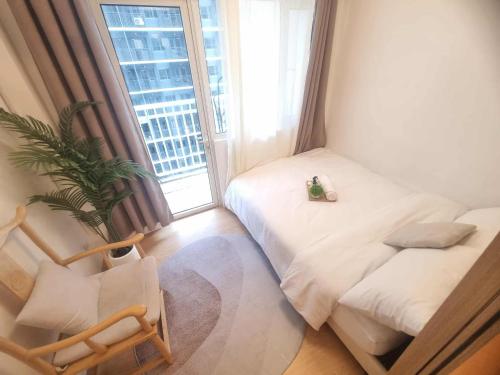a small bedroom with a bed and a window at 953 D shore 1 in Manila