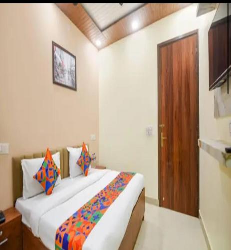 a bedroom with a large bed and a wooden door at Hotel Villa Getaway in New Delhi