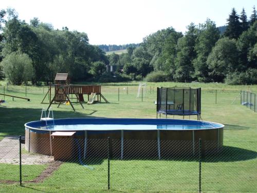 an empty park with a trampoline and a playground at Green Valley Park in Stárkov