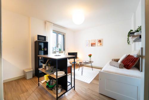 a living room with a couch and a table at Le Pacé - Appartement cosy in Pacé
