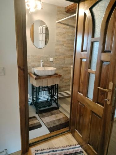 a bathroom with a sink and a mirror at Wild-Traditional Bucovina in Câmpulung Moldovenesc