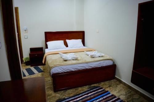 a bedroom with a bed with two towels on it at Nuba Nest in Aswan