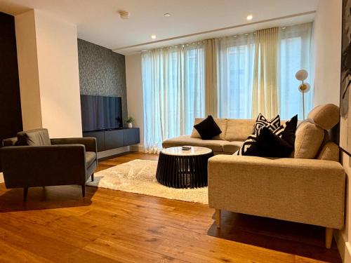 a living room with two couches and a tv at 212 RH - Central York Retreat in York
