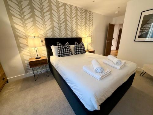 a bedroom with a large bed with towels on it at 212 RH - Central York Retreat in York