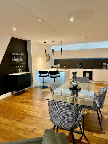 a living room with tables and chairs and a kitchen at 212 RH - Central York Retreat in York