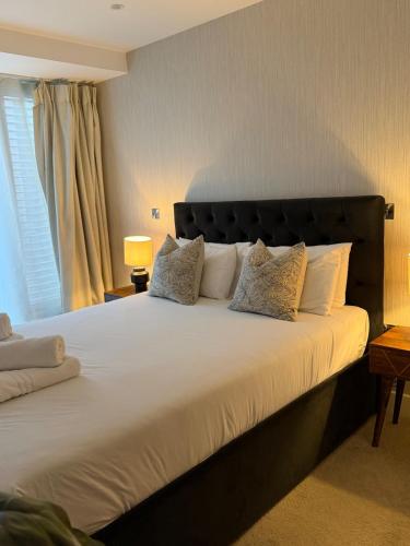 a bedroom with a large white bed with pillows at 212 RH - Central York Retreat in York