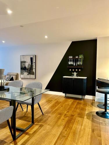 a living room with a table and a piano at 212 RH - Central York Retreat in York