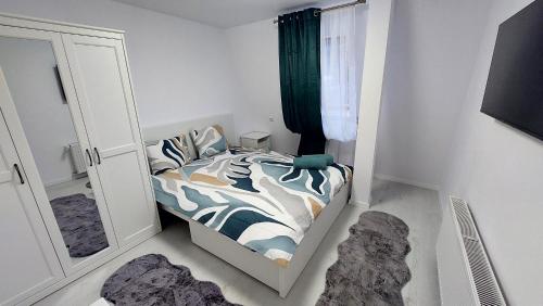 a bedroom with a bed with a zebra print sheets at Moonriver Alps Ski Apartament in Ramingstein