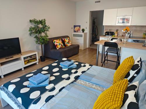 a living room with a couch and a table at Comfort flat with great location in Prague