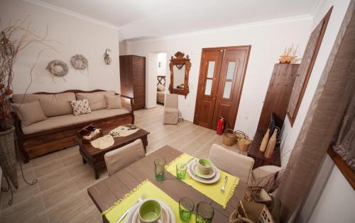 a living room with a couch and a table at Kaminos Boutique Hotel in Symi