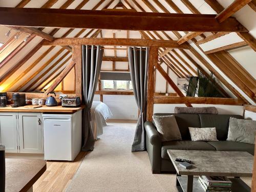 a living room with a couch and a table at The Granary in Hurstpierpoint
