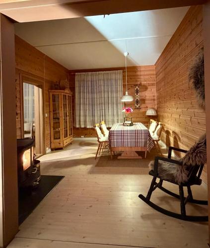 a living room with a table and a fireplace at Valhalla Hytte in Oppdal