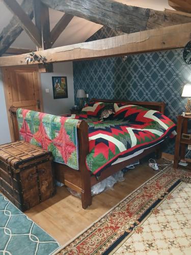 a bedroom with a bed and a couch at La Belle Maison in Piégut-Pluviers