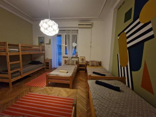 una stanza con letti a castello e un soggiorno con divano di HostelChe Hostel a Belgrado