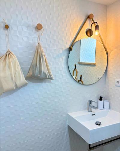 a bathroom with a sink and a mirror at Casa do Pastor - Vale de Alfaia in Sobral do Campo