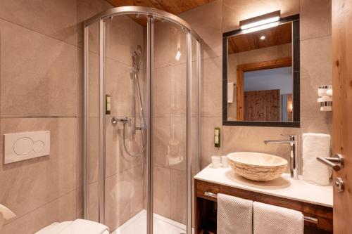 a bathroom with a shower and a sink at Hotel Eggerwirt in Söll
