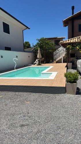 a swimming pool in the middle of a house at Cabanas da Vó Nena in Palhoça