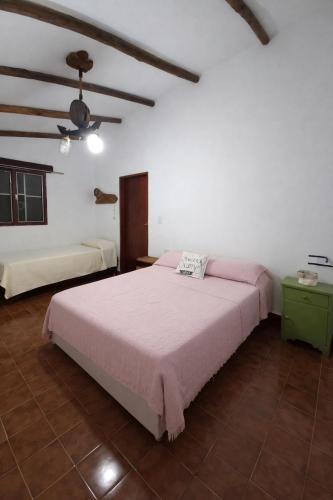 a bedroom with a large bed in a room at El Bosque de Simba - Casa in La Estancia