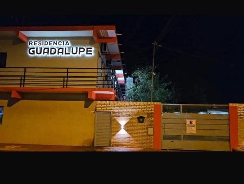 a building with a sign on the side of it at Residencia Guadalupe in Colonia Río Verde