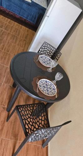 a table and chairs with plates and bowls on it at Residencia Guadalupe in Colonia Río Verde