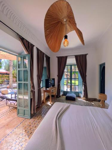 a bedroom with a bed and a ceiling fan at Villa Riad Marrakech in Najem