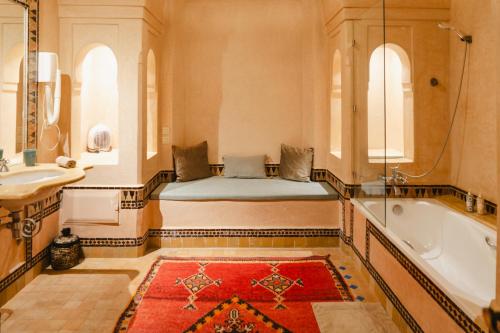 a bathroom with a bed and a tub and a sink at Villa Riad Marrakech in Najem