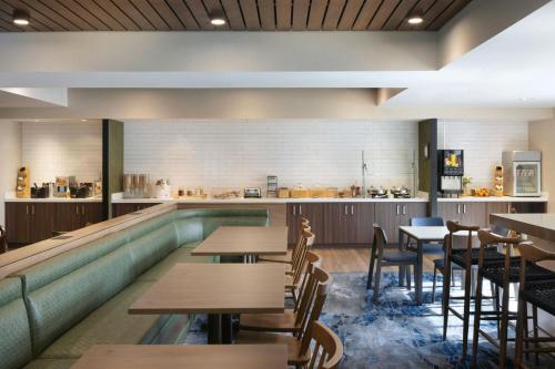 a restaurant with tables and a swimming pool at Fairfield Inn Las Vegas Convention Center in Las Vegas