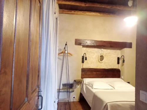 a bedroom with a bed and a lamp in it at Gite rustique de charme chez Santa é Pasquà in San-Martino-di-Lota