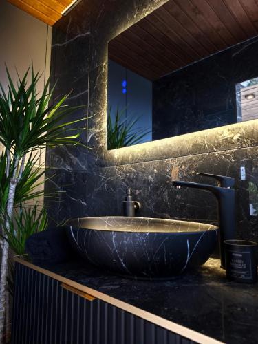 a bathroom with a large sink and a mirror at KotkaPesa in Vihtra