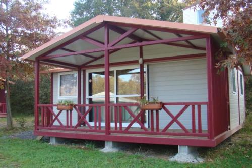 a red screened in porch with potted plants on it at ZEcamping 4 animaux acceptés hammam sauna piscine et soirées animées in Espelette