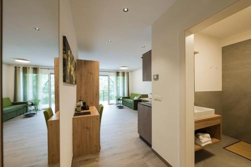 an open kitchen and living room in a house at Villa Rosengarten Guesthouse in Merano