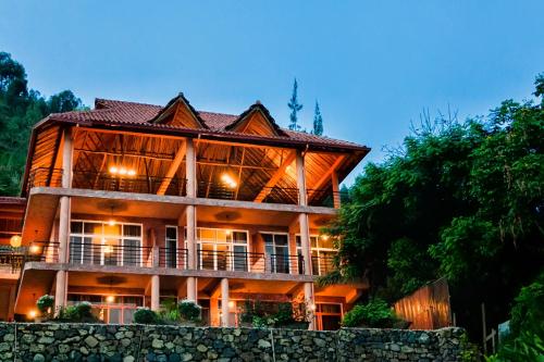 a large building with a fence in front of it at Hakuna Matata Lodge in Gisenyi