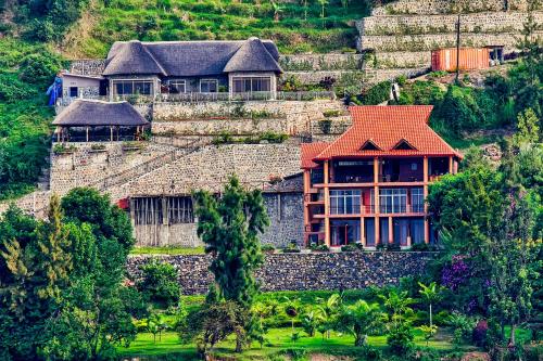 a house on the side of a mountain at Hakuna Matata Lodge in Gisenyi