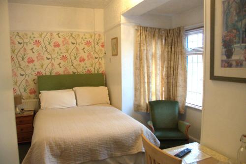 a small bedroom with a bed and a window at Walcot House in Fawley