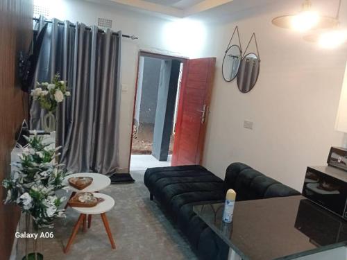 a living room with a couch and a table at Wamis serviced apartments in Solwezi