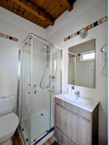 a bathroom with a shower and a sink and a toilet at Orange3 Hostel in Lagos