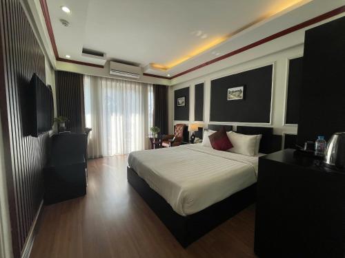 a bedroom with a large bed in a room at Viet Hotel in Hanoi